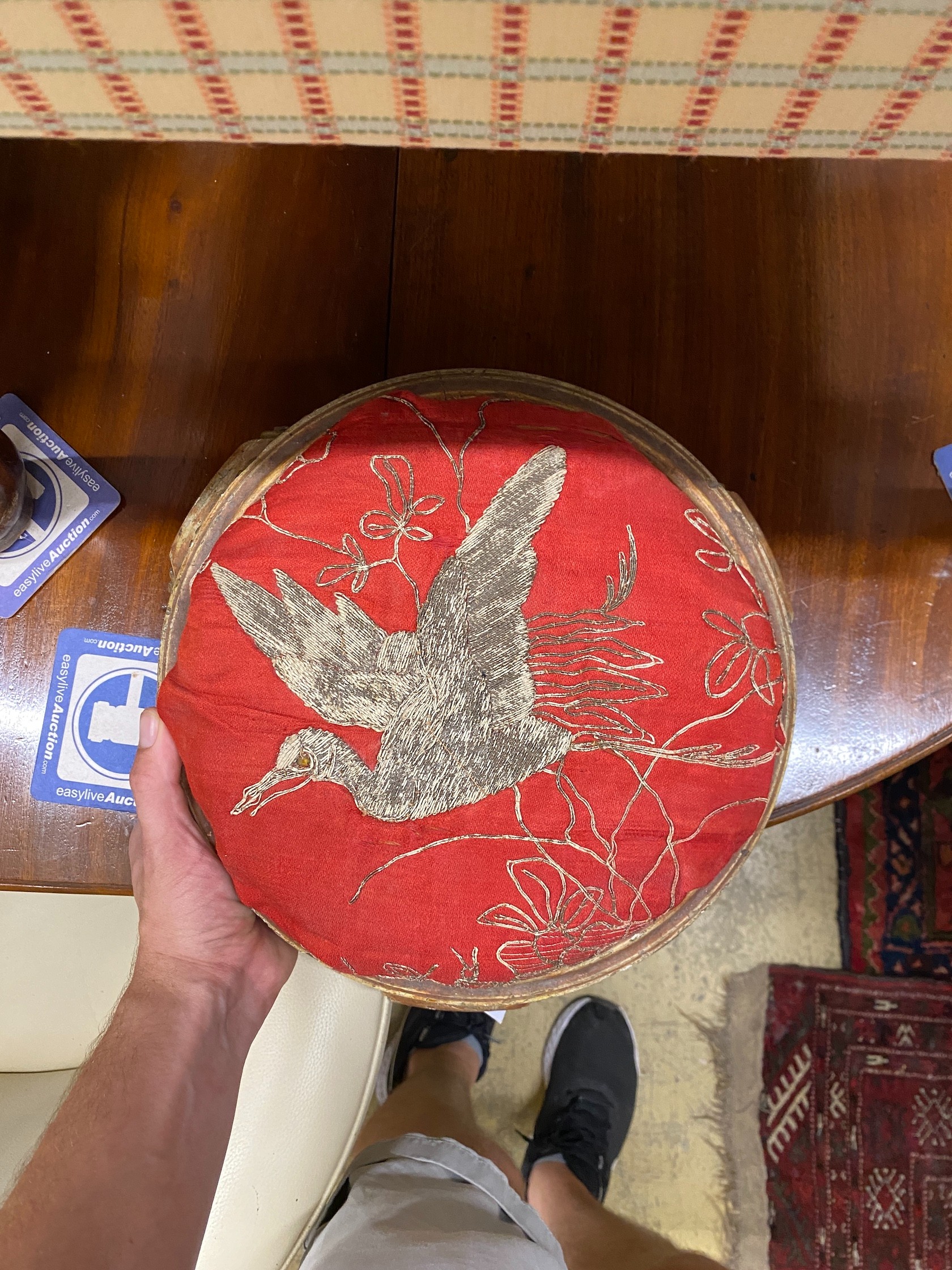 A Victorian carved giltwood footstool, diameter 32cm